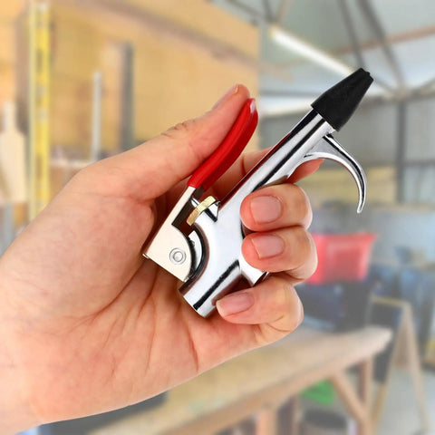Four Sets Industrial Air Blow Gun Kits With Adjustable Nozzles And Steel Tips For Pneumatic Tools Built Tough To Kick Dirt And Debris Out Fast, hand holding chrome air blow gun.