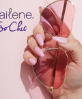 Perfect Bond Nail Glue For Natural And Artificial Nails, hand with pink nails holding pink sunglasses