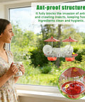 Window Mounted Hummingbird Feeder With Strong Suction Cups Bee Proof Ports Ant Moat And Dual Sun Shades Two Point Six Ounces Capacity Easy To Fill And Clean For Close Up Bird Watching shown installed on window.