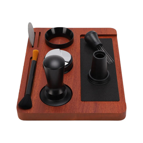 Solid Wood Espresso Tamper Station With Silicone Mat And Seven Piece Barista Gear featuring tools on wooden base for home brewing.