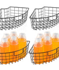 Two black metal wire Lazy Susan baskets with handles; 9x6.2x4 in, for cabinet or fridge storage; shown with orange bottles.
