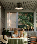 Outdoor porch scene with 2 Pack Industrial Semi Flush Mount Ceiling Lights In Rustic Black Metal Finish illuminating a table.