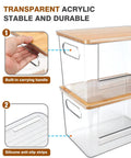 Kicking Clutter Away Trash Bag Dispenser 2 Pack with bamboo top, transparent acrylic, features carrying handle and silicone anti-slip strips.