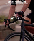 Cyclist riding with Ultra Bright 1100 Lumen Bike Headlight With 270 Degree Wide Beam Auto On Off 6 Modes Daytime Warning 46 Hour Run Time Compatible With Garmin Wahoo Bryton Computers For Night City Rides Ready To Roll on handlebars.