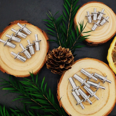 60 Piece Hammer Drive Rivets Aluminum Core Set With Round Head Blind Rivets on wooden discs with greenery