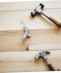 Rugged As Nails Scaffolding Locking Pins Made From Heavy Duty Steel Q235 Set Of Twenty Detachable Coupling Fasteners on wooden boards with hammers.