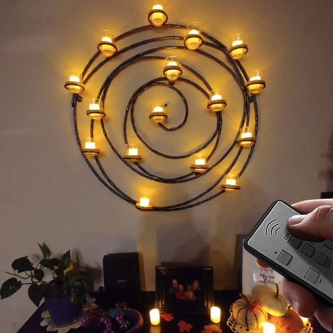 Wall-mounted spiral with Rechargeable Flameless Votive Candles With USB Charge 6 Pack Tea Lights glowing, remote in hand.