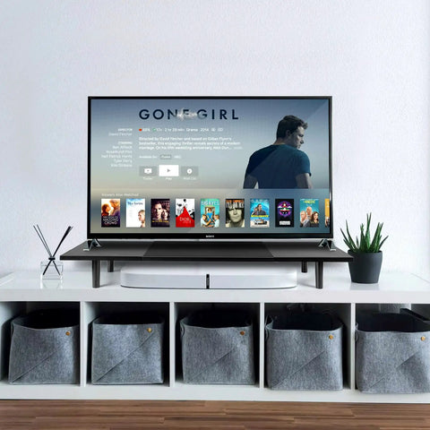 Dual Monitor Stand Riser For Desk With Adjustable Length 32 To 40 Inches Space Saving Desk Shelf Organizer For Two Screen Setup Large Monitor Riser Stand For Computer Laptop PC Printer TV Black featuring a television display in a living room setup.