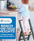 Child standing on one step folding ladder for home office kitchen and studio use, ultra slim bamboo and black aluminum step stool.