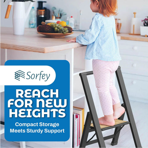 Child standing on one step folding ladder for home office kitchen and studio use, ultra slim bamboo and black aluminum step stool.