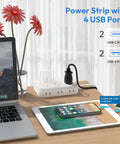 25 Ft Flat Plug Extension Cord With 6 Outlets And 4 USB Ports Heavy Duty Power Strip With Overload Protection For Indoor Use White Right Angle Outlet Extender For Home Office Easy Cable Management on desk with laptop and tablet