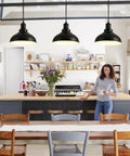 Industrial Black Pendant Lights For Hallway And Kitchen Island Farmhouse Style Hanging Light Fixture With Metal Shade Vintage Barn Chic Ceiling Lamp For Living Room Dining Room Entryway And More displayed in a rustic kitchen setting with wooden cabinets and shelves.