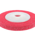Red nylon buffing wheel with a center hole for attachment, designed for efficient high speed grinding on plastic and wood.