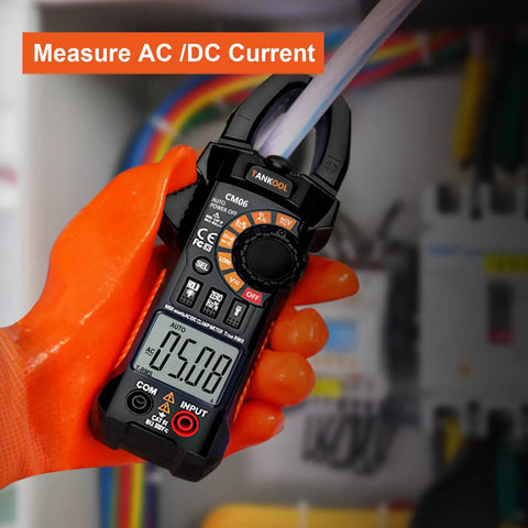 True RMS 6000 Counts Digital Clamp Meter Multimeter Auto Ranging Pro Grade Built In HD Screen measuring AC current in orange gloves
