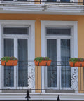 Kick It Up A Notch On Your Deck With These Sturdy Railing Planter Boxes Perfect For Balconies Patios And Windowsills Quick Setup Metal Brackets Included Deep Root Zone For Lush Greenery Classic Red Finish with flowers on a balcony railing.
