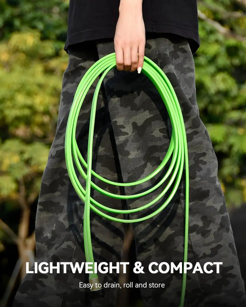Person holding flat soaker hose with stakes, 50 ft for garden and lawn irrigation, lightweight design, green color.