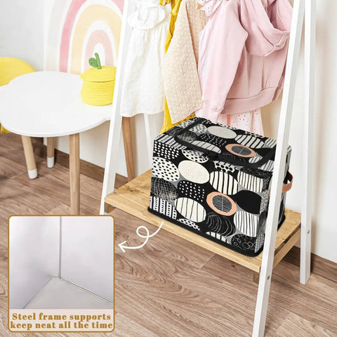 Fan Favorite Black And White Boho Design Storage Bins With Secure Lids Foldable Closet Organizers Featuring Soft Leather Handles For Heavy Duty Washable Home Decluttering on shelf with children's clothes.