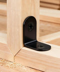 Close-up of a heavy duty black L bracket installed on wood, showcasing corrosion resistant stainless steel build.
