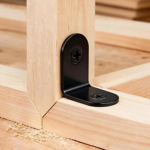 Close-up of a heavy duty black L bracket installed on wood, showcasing corrosion resistant stainless steel build.