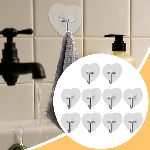 Heavy Duty Adhesive Wall Hooks With Slick Grip Keep Your Towels And Gear Locked In Place Zero Drilling Hassle Clear Transparent Look Fits Any Room Flawlessly, showing gray towel hung on heart-shaped hook.