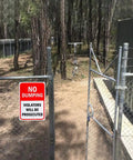 Heavy Duty No Dumping Warning Sign Pair 10 By 7 Inch Rust Free Aluminum Weather Resistant UV Coated, posted on a fence gate.