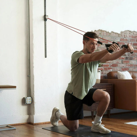 Top Tier Space Saving Home Gym Resistance Band System With Gliding Wall Track Three Foot Aluminum Mount And Five Bands Plus Handles in use.