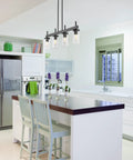 Kitchen with Winslett Linear Pendant In Matte Black With Slick Clear Ribbed Glass Shades for island lighting.