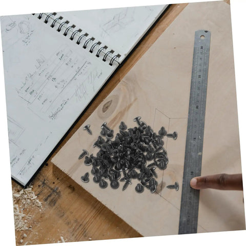 Nailed It With These Dope 100 Piece Miniature Metal Screws on wood with ruler and sketch notebook for DIY furniture assembly.