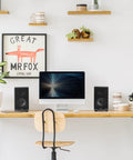 R33BT Bluetooth Bookshelf Speakers And 2.0 Powered Studio Monitors Black Wood Enclosure Pair on desk next to computer