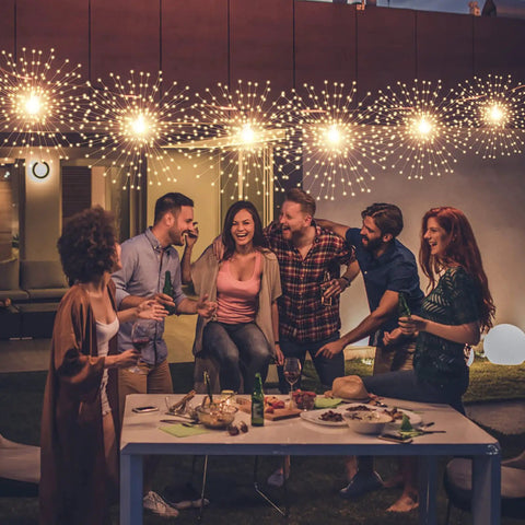 Dope 200 LED Hanging Sphere Lights Battery Operated Starburst Fairy Lights with people at outdoor party