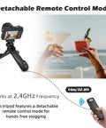 Vlogging Hand Grip Tripod With OLED Rechargeable Wireless Cam Remote in use by seaside, showing detachable remote mode.
