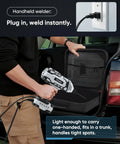 Person holding Portable Handheld Welder Gun With 5 Level Current, IGBT Arc Welder, plugging into outlet, beside car trunk