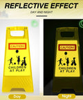 Reflective day and night view of Four Pack 24 Inch Slow Down Kids At Play Sign Reflective Double Sided Street Safety Signs in yellow with caution graphics.