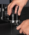 Straight Fire Dual Bearing Espresso Distributor And Tamper Combo Fits 51 54 58mm Filter Baskets, close-up of hands positioning tool.