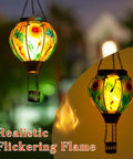Hot Air Balloon Solar Lantern For Outdoor Use, Dragonfly Inspired Glass Hanging Light illuminating garden with warm glow