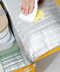 Close-up of a Lightweight Foldable Insulated Picnic Cooler Bag With Zippered Top And 24L Capacity, showing the interior silver insulation.