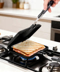 Elsjoy Stovetop Toasted Sandwich Maker Press, aluminum flip pan with handle cooking sandwich on stove.
