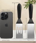 Small metal spatula set of 3 with black handles; front view with slotted and solid blades.