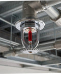 10 Pack Solid Copper Fire Sprinkler Heads 155F Upright Spray Half Inch Npt Thread mounted on ceiling with visible red glass.
