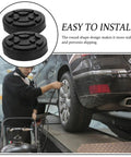 Vosarea Heavy Duty Car Lift Pads Set Of Four Round Auto Jacking Rubber Mats for Two Post Hoist used on a vehicle during maintenance.