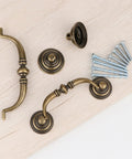 Antique Drop Bail Drawer Pulls Set Of Four In Bronzed Finish with 25mm and 45mm screws shown on wooden surface