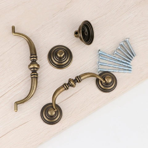 Antique Drop Bail Drawer Pulls Set Of Four In Bronzed Finish with 25mm and 45mm screws shown on wooden surface