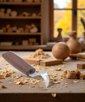 Top Shelf Walnut Handle Wood Carving Hook Knife And Spoon Gouge With Double Sided Curved Blades on a woodwork table.