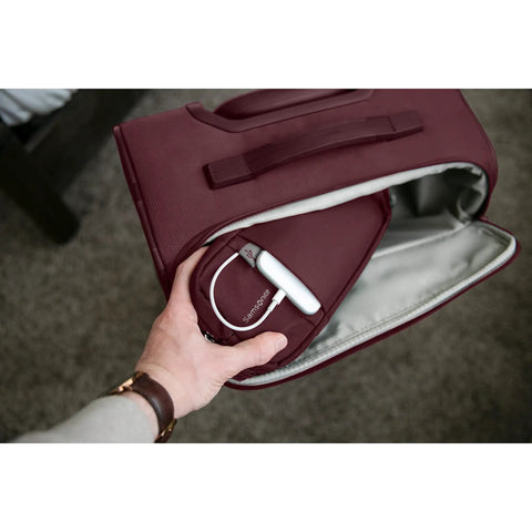 Hand accessing side pocket of Lineate Softside Expandable Go To Carry On Luggage with Spinner Wheels Cedar Green Effortless Glide.