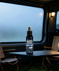 Glass Frosting Spray 30ml Translucent Portable Privacy Agent on table with RV window privacy effect in background.