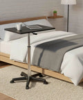 Flexible Mobile Standing Desk With Smooth Rolling Wheels And No Sweat Height Adjustments Solid Flat Top Laptop Table on bedside.