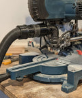Top Notch Miter Saw Dust Adapter 2-1/2 Inch For Bosch Gcm12sd attached to miter saw for efficient dust collection.