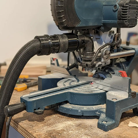 Top Notch Miter Saw Dust Adapter 2-1/2 Inch For Bosch Gcm12sd attached to miter saw for efficient dust collection.