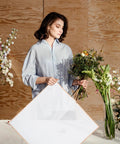 Person wrapping bouquet with Floral Bouquet Wrapping Paper Waterproof Protective Wrap Paper 20 Sheets Cuttable For Flowers And Bouquets