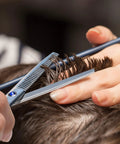 Close-up of using Pro Grade Hair Cutting Scissors And Thinning Shears Kit for barbers, trimming hair with precision.